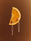Gold Paperclip Drop Earrings on orange slice