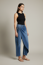 Angled view showing the asymmetric wrap detail and barrel-leg shape of the Porto jean